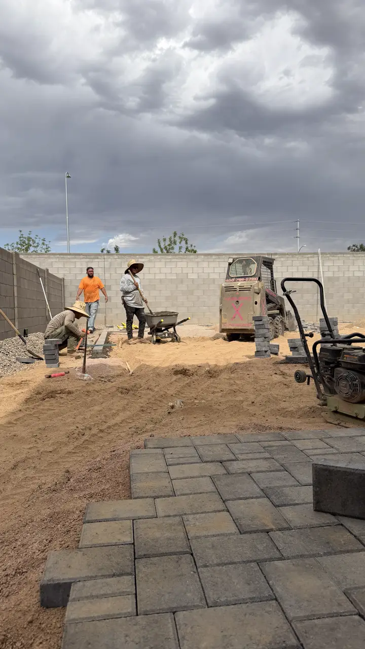 Vaquero X crew laying pavers in a backyard